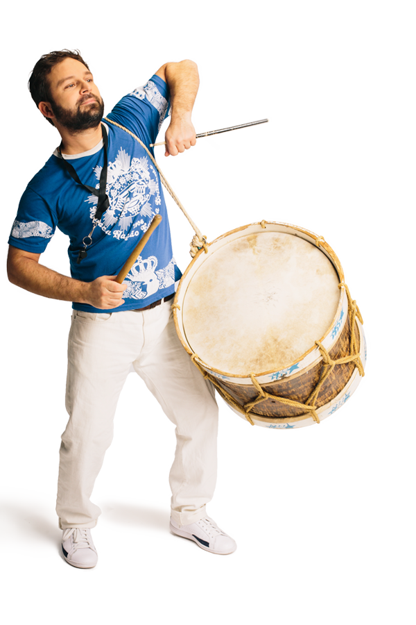 With a big drum strung across his shoulder, Alexander Bordokas extends his arms, with drumsticks in his hands